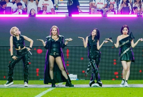 All four 2NE1 members performing together at the Coupang Play Series halftime show at Seoul World Cup Stadium in August 2025