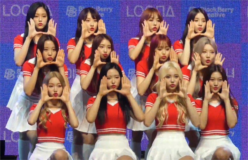 All twelve LOONA members on stage at their debut showcase in August 2018